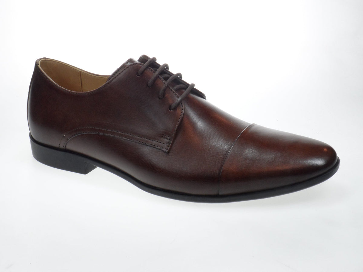 The Anatomic Panorama Chestnut Oxford Shoes are shown from multiple angles. One image captures the side view, highlighting the sleek, polished leather upper with subtle burnished details and neat stitching along the seams. Another shows the shoe from an angled perspective, emphasizing the classic round toe and smooth, refined silhouette.