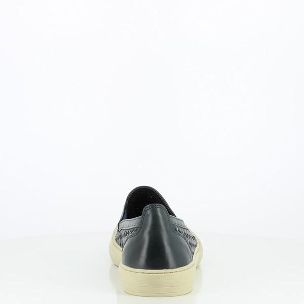 The back view showcases the rounded heel, designed with a textured sole for grip. The stitching at the heel is precise, connecting the leather upper seamlessly with the base.