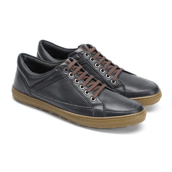 This angled view captures the shoe's depth and structure, emphasizing the rounded toe and comfortable fit. The subtle sheen of the leather and the precision of the craftsmanship are evident, offering a glimpse of the sneaker’s overall profile.