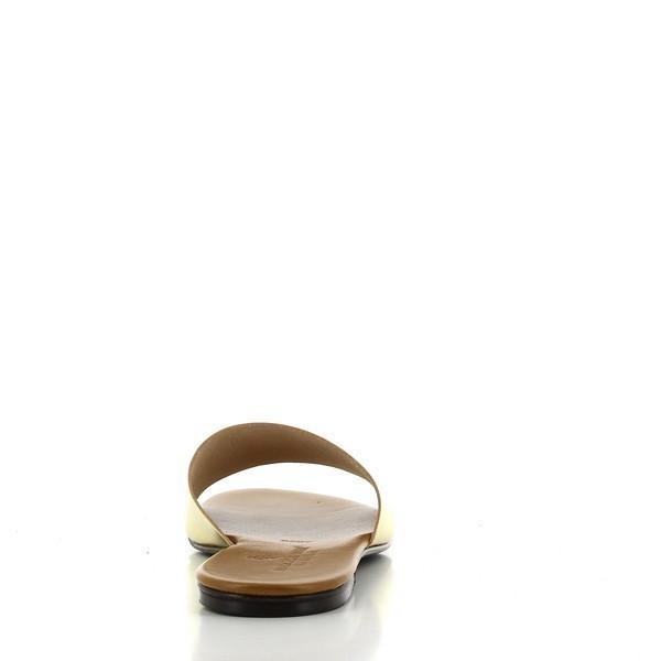 The back of the shoe showcases the clean lines and the elegant profile of the slide, with the heel height and overall design coming together seamlessly. The simplicity of the design is highlighted, making it an ideal choice for the modern, stylish woman.
