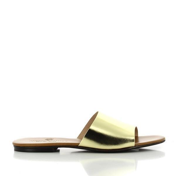 The side of the shoe highlights the sleek silhouette and elegant gold leather, reflecting light beautifully. The smooth finish emphasizes the quality of the material, while the minimalist design allows the craftsmanship to shine.