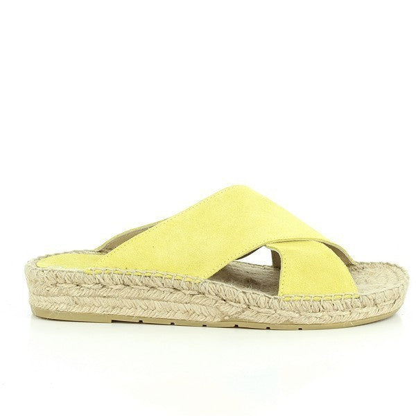 A pair of Calzanor 1809 Cross-Strap Espadrilles in a cheerful yellow tone, exuding warmth and positivity. The leather upper is designed with stylish cross-straps for a secure fit, while the eco-friendly yute sole offers breathability and comfort. These espadrilles are an ideal choice for those looking to add a bold splash of color to their wardrobe, perfect for summer outings or casual gatherings.