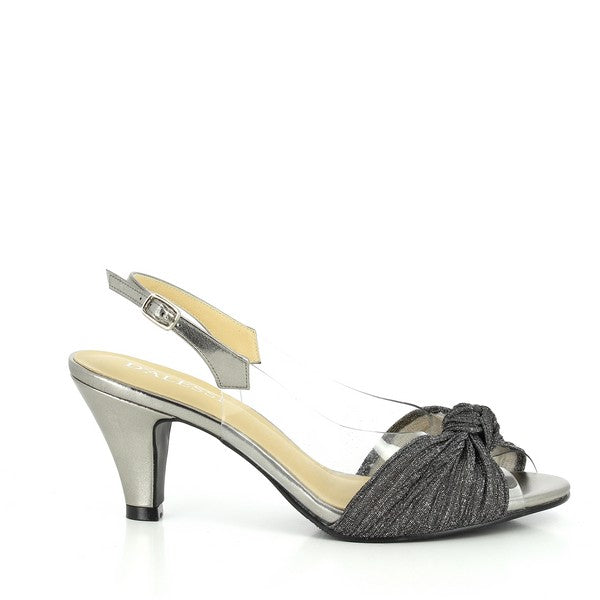The photo displays a pair of Dalessi Dabble Pewter Slingback Heels, showcasing their elegant metallic pewter finish. The peep-toe design reveals a glimpse of the toes, while a decorative front knot adds a refined touch. Transparent side panels enhance the contemporary look, adding a light and airy feel to the shoe. The slingback strap provides secure support around the heel, and the 7 cm heel height gives the perfect lift, blending style with comfort.