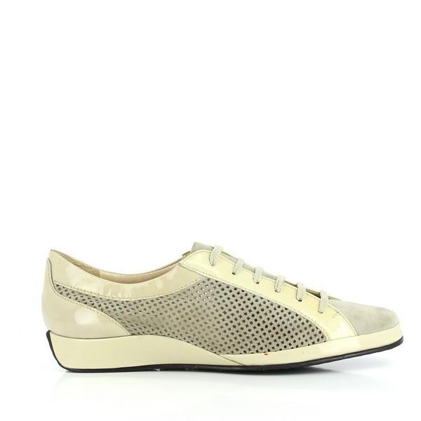 The sneaker's side profile showcases the sleek and sophisticated design, highlighting the colonial gold leather upper. The clean lines and subtle stitching emphasize the quality craftsmanship. The synthetic sole is visible, providing a glimpse of the shoe's durable foundation.