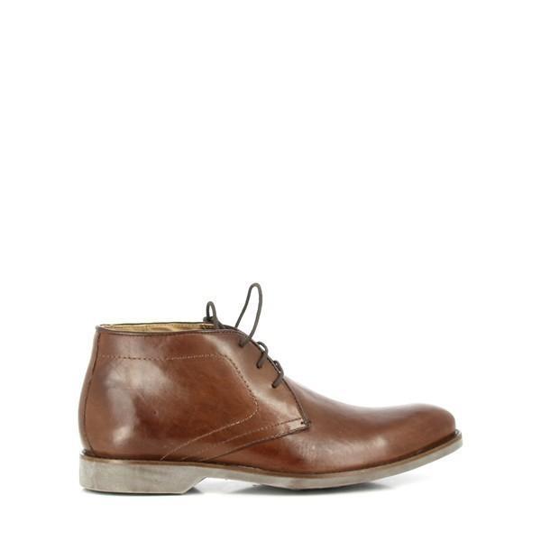 This side view of the Anatomic Barium Coffee Ankle Boot highlights its smooth, full-grain leather upper and sleek silhouette. The photograph emphasizes the boot’s elegant profile, sophisticated burnished finish, and meticulous craftsmanship, showcasing its rich coffee color and refined stitching details.