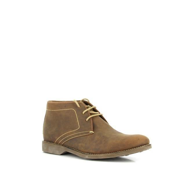 This angled side view of the Anatomic Barium Cognac Ankle Boot provides a dynamic perspective on its sleek profile. The image emphasizes the boot’s rich cognac color, smooth leather texture, and subtle design details, including the burnished finish and fine stitching.
