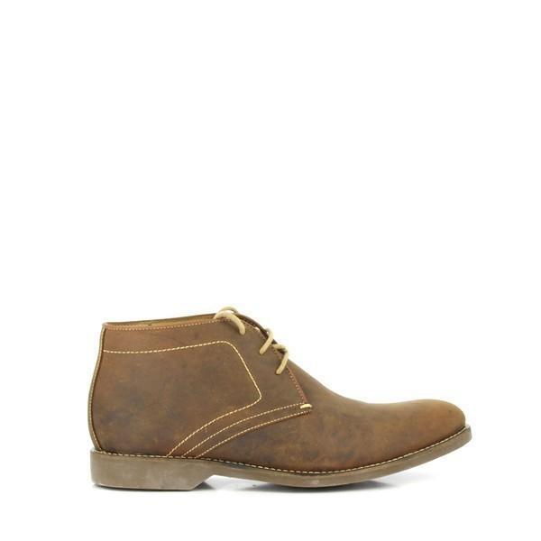 This side view of the Anatomic Barium Cognac Ankle Boot highlights its elegant silhouette and smooth, cognac leather upper. The photograph captures the refined stitching and sophisticated burnished finish, showcasing the boot's classic design and high-quality craftsmanship.