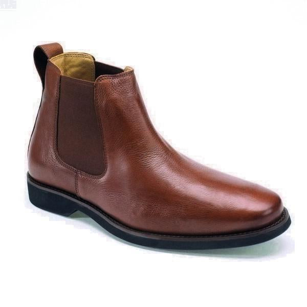 A detailed side view of the Anatomic Cardoso Pinhao Ankle Boot, highlighting the smooth, supple leather upper with a rich, deep hue. The angle captures the elegant silhouette and sophisticated burnished finish, showcasing the boot's refined craftsmanship.