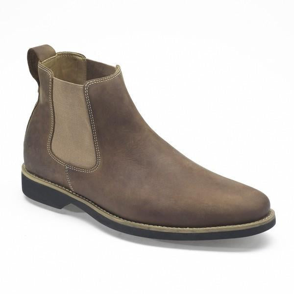 A close-up shot of the Anatomic Cardoso Cognac Ankle Boot, showcasing the smooth, supple leather upper with a vintage burnished finish. The angle highlights the fine stitching and the elegant curve of the boot’s silhouette.