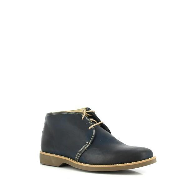 Viewed from a slight angle, the boots reveal their refined silhouette. The rich navy leather is accentuated by the subtle sheen, and the sophisticated design of the lace-up front is complemented by the cushioned footbed visible through the side.
