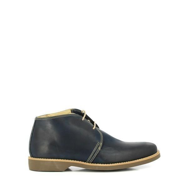 The Anatomic Colorado Navy Lace-Up Boots are displayed from the side, showcasing their sleek navy leather upper. The smooth, burnished finish highlights the quality of the leather, while the round toe and neatly arranged laces add to the classic appeal.
