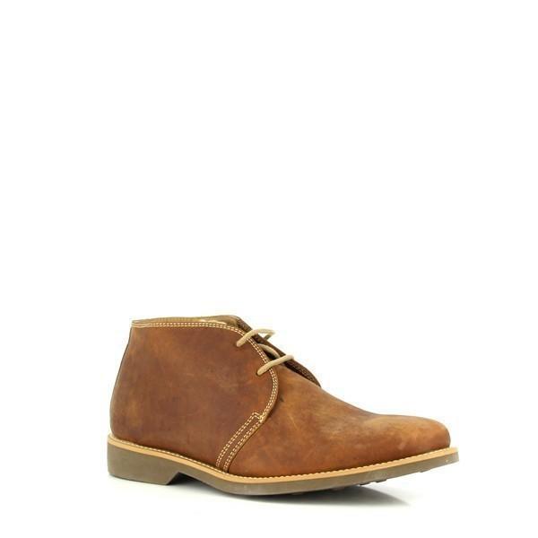Viewed from a slight angle, the boots reveal their classic silhouette and sophisticated profile. The rich cognac leather gleams with a vintage sheen, and the laces are neatly tied, offering a glimpse of the cushioned footbed and the comfortable rounded toe.