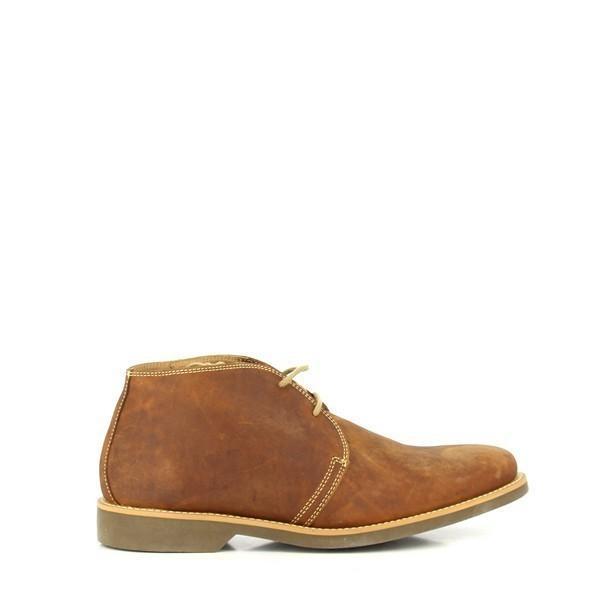 The Anatomic Colorado Cognac Lace-Up Boots are showcased from the side, highlighting their sleek, cognac leather upper with a smooth, burnished finish. The round toe design and elegant lacing are clearly visible, complemented by the subtle stitching details.