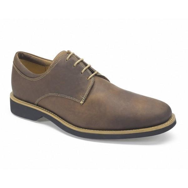 An angled shot capturing the elegant silhouette and fine craftsmanship of the Anatomic Delta Cognac Oxford Shoes, focusing on the polished leather, gentle curves, and the slight heel elevation.


