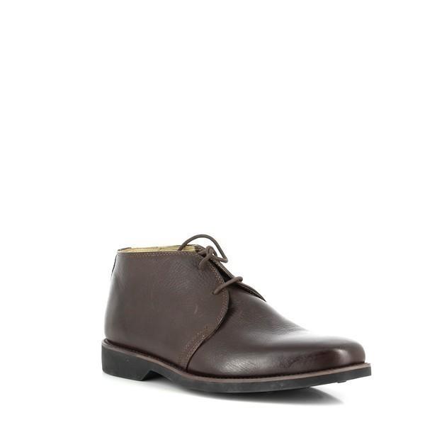 The angled side view emphasizes the burnished leather finish and the elegant, vintage look of the boots. The subtle curve and cushioned footbed are visible, hinting at the comfort and support provided.