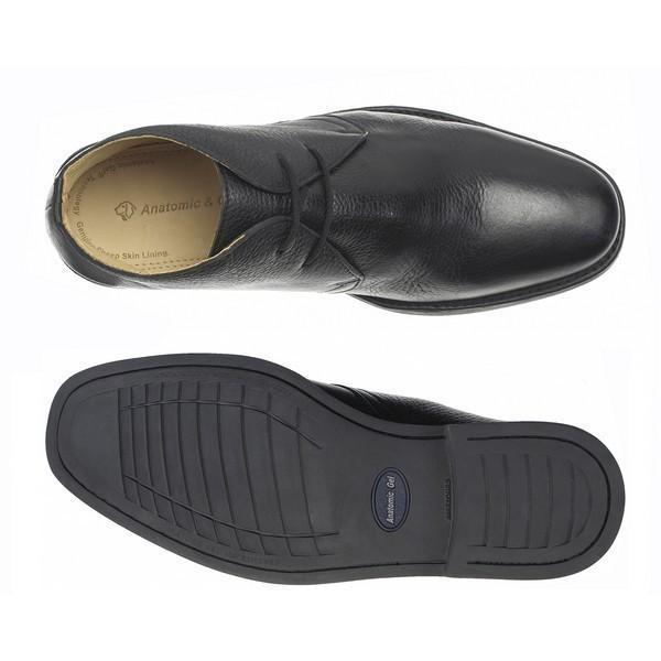 A top-down view showing one boot upright and the other upside down, highlighting both the soft leather upper and the textured non-slip sole with Anatomic Gel Technology®. The contrast between the sophisticated upper and the durable, flexible sole is clearly visible.