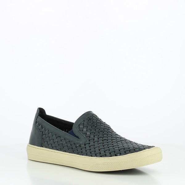 This angled view highlights the shoe's leather texture, the raised stitching on the side, and the distinct contrast between the leather upper and the flexible sole, giving a better sense of the shoe's structure and depth.