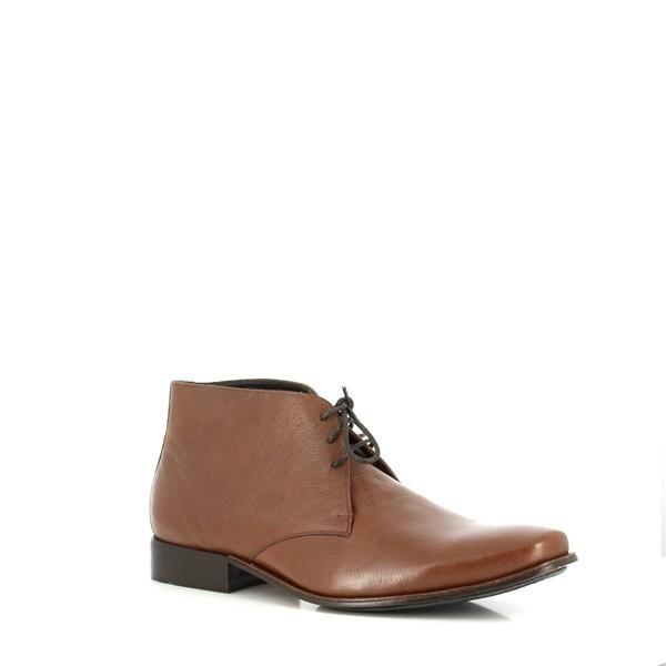 From an angled perspective, this image emphasizes the burnished brown leather with its rich, vintage finish. The lace-up closure and sturdy build are clearly visible, demonstrating the craftsmanship. The slightly elevated heel and durable outsole complete the boot's elegant, rugged look.