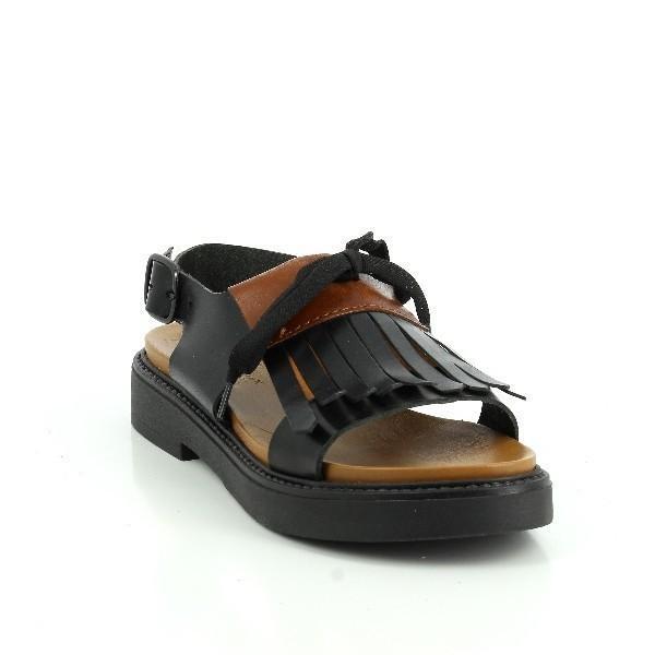 This angled view highlights the dynamic design of the sandals, emphasizing the subtle curve of the heel and the distinctive fringe accents. The interplay between the black and tan leathers creates a striking contrast, enhancing the shoe's visual appeal. The 3 cm heel-platform is visible, offering a slight lift while maintaining comfort. This perspective also allows a glimpse of the interior lining, hinting at the luxurious feel inside.