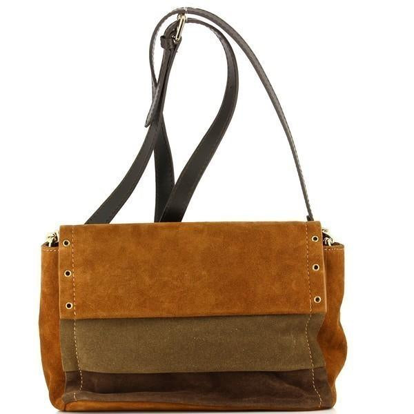 The Bridas 1921 Tobacco Crossbody Bag is elegantly displayed against a soft, neutral background. The bag showcases its rich tobacco leather exterior, highlighting its luxurious texture and quality craftsmanship. The adjustable strap hangs gracefully, emphasizing its versatility for everyday wear. The interior lining is subtly visible, hinting at the attention to detail that goes into each design. This chic accessory combines style and functionality, making it a perfect addition to any woman's collection.