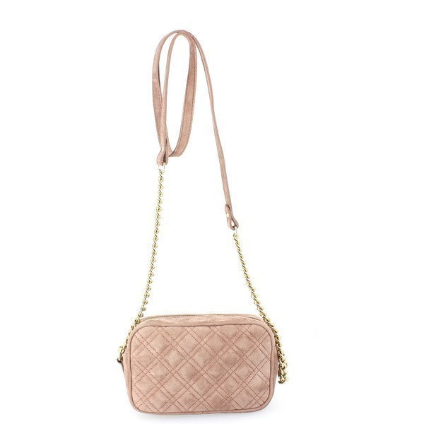 A stylish Bridas 647 Rose Crossbody Bag rests elegantly on a soft, neutral background, showcasing its premium leather exterior in a lovely rose hue. The bag features a sleek, compact design with an adjustable strap that gracefully drapes to one side. The rich texture of the leather contrasts beautifully with the soft lining visible through the open flap, highlighting the attention to detail. The bag's size, measuring 11cm in height and 18cm in width, makes it ideal for carrying essentials .