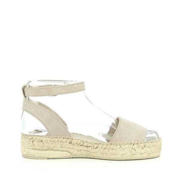 This photo captures the Calzanor 1948 Nude Slingback Espadrilles from the side, showcasing their sleek and elegant profile. The soft nude leather upper highlights the refined craftsmanship and supple texture. The round toe design adds a classic touch, while the slender slingback strap gently curves around the heel for a secure fit. The espadrille's natural jute sole is prominently featured, emphasizing its eco-friendly construction and artisanal quality. 