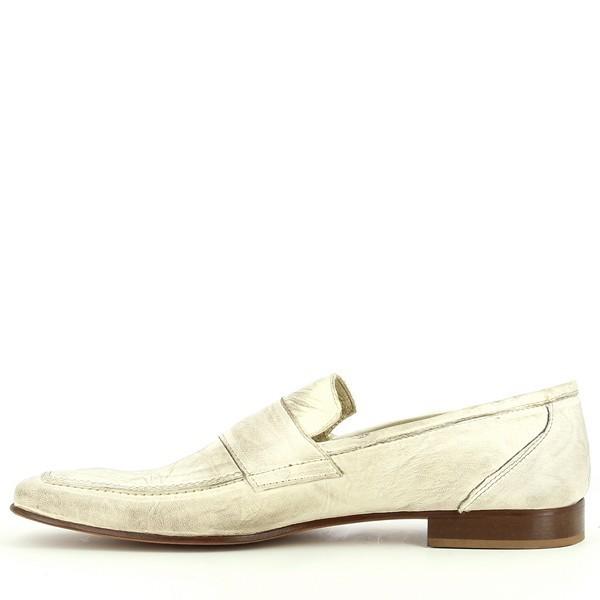 The inside of the moccasin is shown, focusing on the leather lining and insole. The comfortable and smooth interior of the shoe is visible, designed to provide all-day comfort.