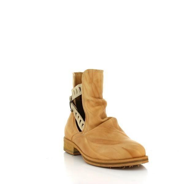 A slightly angled shot capturing the front and side of the boots, emphasizing the craftsmanship of the decorative straps, the golden buckle details, and the rich texture of the leather.