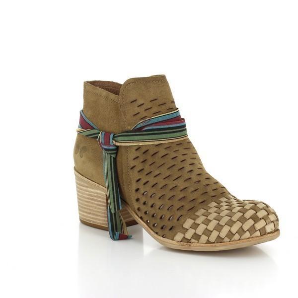A dynamic side angle view, emphasizing the shape and curvature of the ankle boot. The stylish beige and tan squares are visible, and the smooth leather finish gives the boot an elegant look. The internal zipper is subtly integrated into the design.