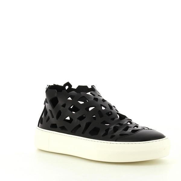 An angled view highlighting the pointed toe design and the unique texture of the hand-finished leather. The back zipper and synthetic sole are subtly visible, emphasizing the blend of elegance and practicality.