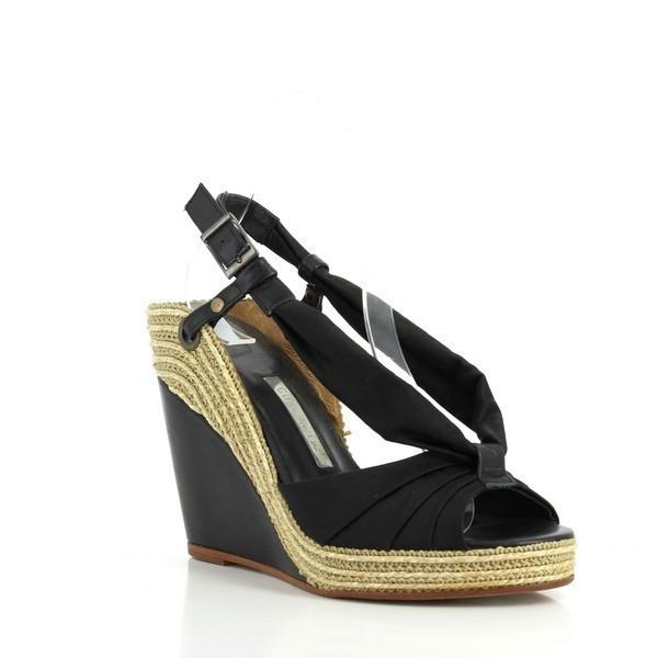 The Gino Vaello 2981 Black Wedges from an angled perspective, highlighting the open-toe design and clean lines of the synthetic material, perfect for a stylish and comfortable look.