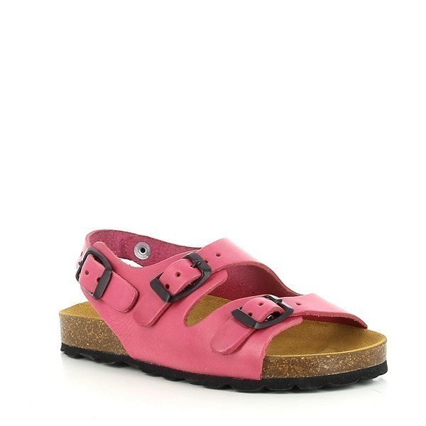 An angled side view of the Plakton 110046 Pink Slingback Kids Sandal. This perspective captures the sleek design, showing the pink leather upper and lining, the low 2.5cm platform height, and the ankle strap for added security. The ridged cork sole is also visible, emphasizing its durability and natural charm.