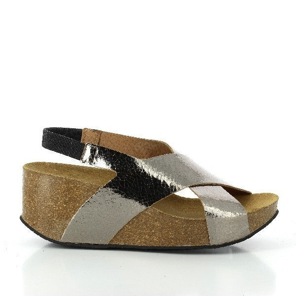 Capture the sleek profile of Plakton's 275027 Cross-Strap Platinum Wedges, showcasing the elegant curve of the leather upper and the subtle sheen of the cork sole.