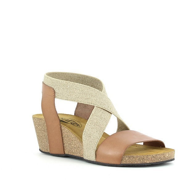 From an angled perspective, highlight the chic design of the sandals, featuring the stylish slingback strap and the detailed craftsmanship. This view captures the blend of fashion and function, showcasing the comfort and elegance of the wedge style.