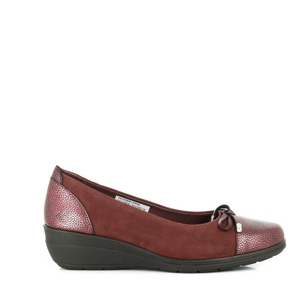 A detailed close-up of the 24 Hrs 23366 Burgundy Pumps, highlighting their luxurious leather upper and elegant design. The rich burgundy color adds a touch of sophistication, while the 4 cm heel provides a graceful lift. The round toe shape and soft leather lining are clearly visible, emphasizing comfort and style. The synthetic sole ensures durability and traction. The background is neutral to keep the focus on the pumps' exquisite craftsmanship and vibrant color.