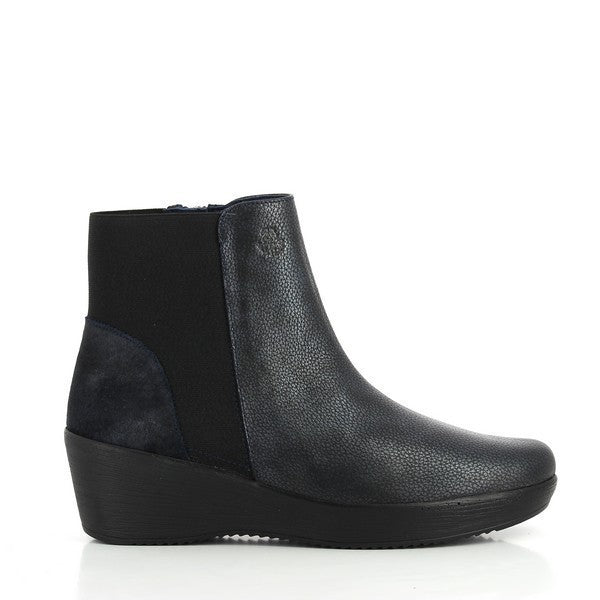A close-up image of the 24 Hrs 23418 Navy Ankle Boots, highlighting the sleek navy leather upper and the practical internal zipper. The 5 cm heel is visible, emphasizing the stylish lift, while the soft leather lining and durable synthetic sole are shown, showcasing comfort and functionality. The neutral background enhances the elegant design and craftsmanship of these women's ankle boots.