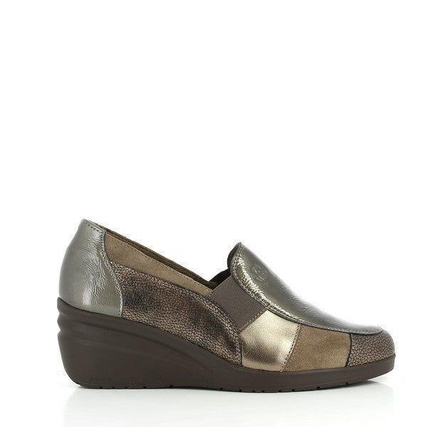 A close-up image of the 24 Hrs 23425 Taupe Slip On Loafers, highlighting the elegant taupe leather upper and classic slip-on design. The 6 cm heel is visible, adding a stylish lift, while the soft leather lining and durable synthetic sole are shown, emphasizing comfort and functionality. The neutral background accentuates the refined craftsmanship and versatile nature of these women’s loafers.