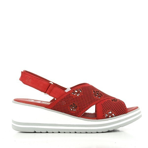 A pair of 24 Hrs 23681 Red Slingback Wedge Sandals is elegantly displayed on a neutral background. The sandals showcase a bold red leather upper with intricate floral details that add a touch of sophistication. The cross-straps and adjustable velcro slingback ensure a secure fit, while the 5 cm wedge heel provides a stylish lift. The soft leather lining and durable synthetic sole are visible, highlighting the high-quality craftsmanship and comfort of these women’s shoes.
