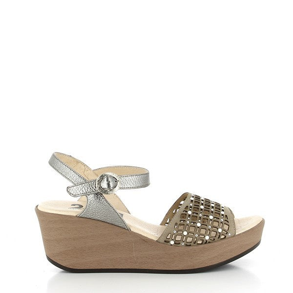 A pair of 24 Hrs 24050 Cana Silver Slingback Wedges is displayed on a clean, light background. The wedges feature a sleek silver leather upper with a soft sheen, and a round toe shape. The adjustable slingback strap is visible, ensuring a secure fit. The 5.5 cm wedge heel is sturdy, offering a comfortable lift while maintaining balance. The leather lining is slightly visible from the top, hinting at the comfort within. The overall design exudes a blend of elegance and practicality, perfect for both casual a