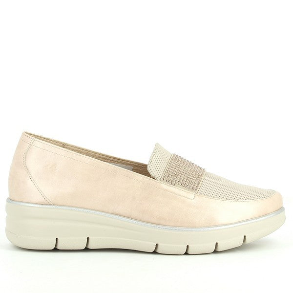 A pair of 24Hrs 24472 Nude Loafers are displayed against a neutral background. The loafers feature a smooth, light nude leather upper with a subtle sheen. The shoes have a round toe shape and a low 3cm heel, offering a classic yet modern look. The leather lining is visible inside the shoes, highlighting the quality craftsmanship. The synthetic sole adds a slight contrast to the overall design. The loafers are positioned to showcase their sleek profile and elegant design, making them look both stylish and co