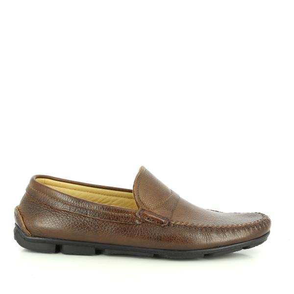 A side view of the Anatomic Kempt Troy Brown Driver Shoes. The image highlights the rich, brown full-grain leather upper with a smooth, burnished finish that exudes sophistication. The round toe design is evident, along with the fine stitching that adds to the handcrafted quality. The flexible, non-slip sole featuring Anatomic Gel Technology® is partially visible, indicating the shoes' superior grip and comfort. 