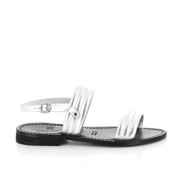 The Antichi Romani 010 Argento Silver Slingback Sandals are elegantly displayed with their shimmering silver leather upper, catching the light to highlight its luxurious texture. The 2cm heel adds a sophisticated lift, while the classic round toe design enhances the sandal's timeless appeal. The soft leather lining and sole ensure comfort and breathability. The sandals are shown against a neutral backdrop, emphasizing their refined craftsmanship and striking silver finish.