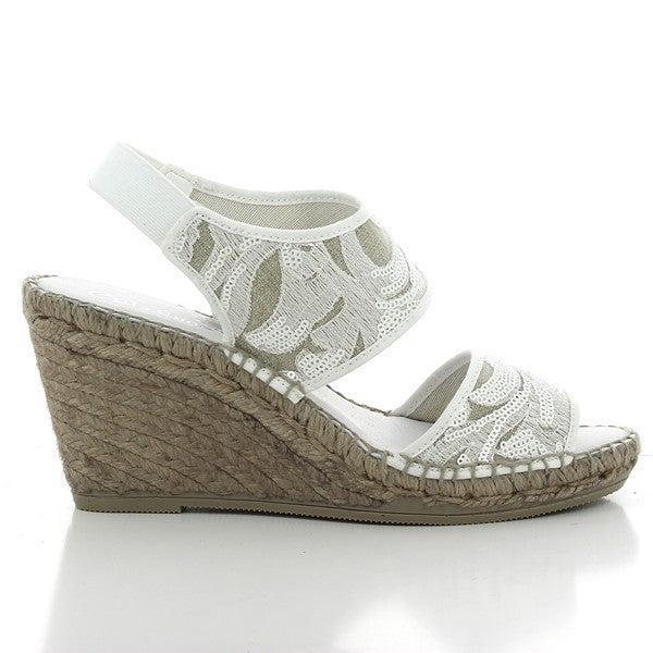 The Calzanor 1304 White Slingback Espadrilles are elegantly showcased, highlighting their chic and sophisticated design. The espadrilles feature a pristine white leather upper with a classic round toe, exuding a fresh and modern aesthetic. The adjustable slingback strap provides both style and comfort, ensuring a secure fit. Set against a neutral backdrop, the eco-friendly jute sole is prominently displayed, emphasizing the brand's commitment to sustainable craftsmanship. 