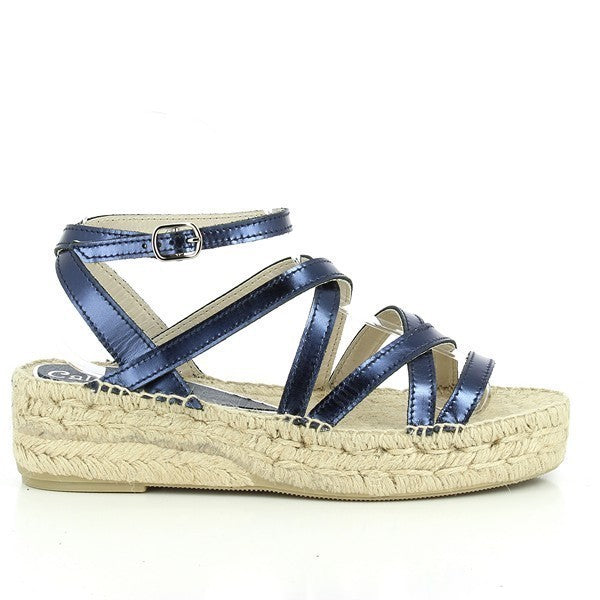 The Calzanor 1417 Blue Multi-Strap Espadrilles are elegantly displayed, highlighting their chic design and artisanal craftsmanship. The espadrilles feature a vibrant blue leather upper with multiple stylish straps that create a modern yet classic look. Set against a neutral backdrop, the round toe shape and 3 cm heel are prominently showcased, emphasizing comfort and versatility. The eco-friendly jute sole is visible, reflecting Calzanor's commitment to sustainability. 