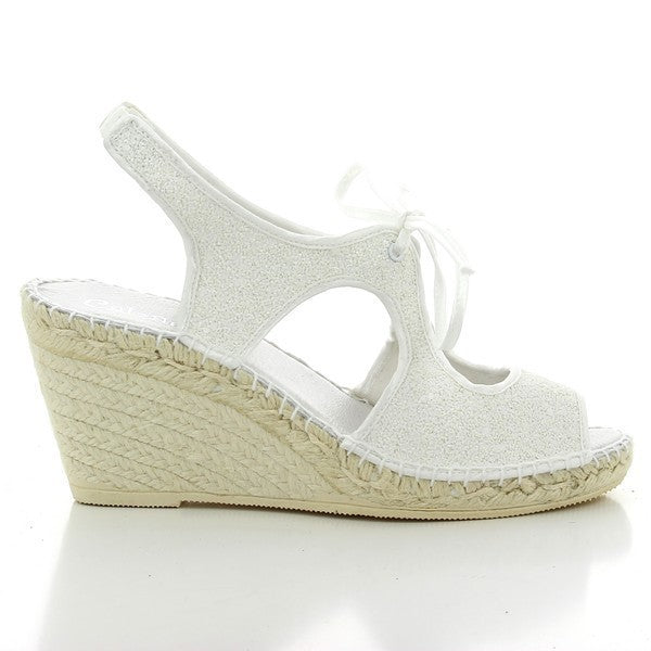 The image showcases the Calzanor 2038 White Slingback Espadrilles, exuding a fresh and stylish aesthetic. The pristine white leather upper gleams under soft lighting, highlighting the shoe's elegant design. A natural jute sole wraps around the bottom, providing a classic espadrille look. The 9 cm platform heel offers a subtle lift, while the round toe shape adds a touch of timeless sophistication. 