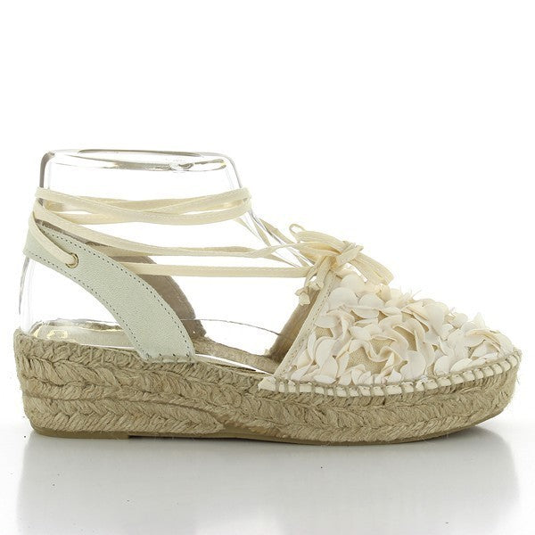 The Calzanor 2046 White Lace-up Espadrilles are elegantly presented, showcasing their pristine white leather upper and chic lace-up design. The soft leather contrasts beautifully with the natural jute sole, which peeks out from underneath, highlighting the classic espadrille craftsmanship. The round toe shape ensures a comfortable fit, while the laces add a stylish detail that enhances the overall design. Soft, diffused lighting accentuates the texture of the leather and the intricate hand-stitched details.