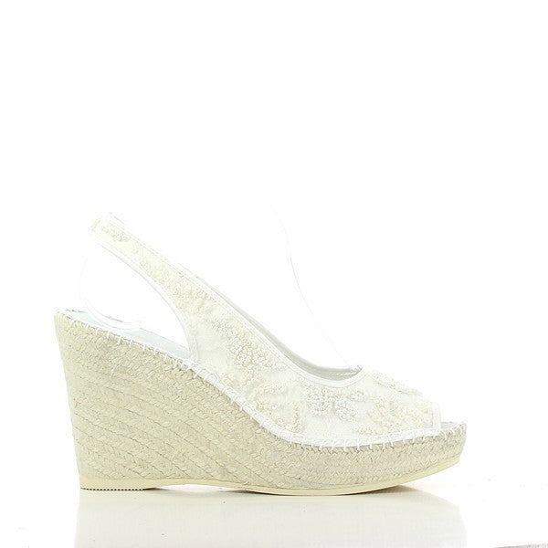 A pair of Calzanor 224 Agata White Slingback Espadrilles is displayed elegantly against a soft, neutral background. The espadrilles feature a sleek white leather upper with a peep toe design and a round toe shape, exuding sophistication and charm. The stylish slingback strap, also in white leather, offers a comfortable fit while adding a touch of elegance. The espadrilles are set atop a robust synthetic sole with a 10 cm heel, highlighting their chic height and versatility. 