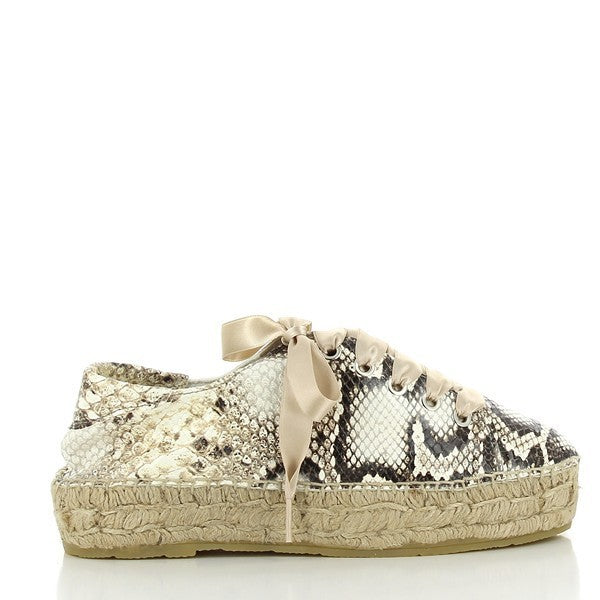 The Calzanor 2251 Natural Lace-Up Espadrilles are elegantly displayed against a neutral backdrop, showcasing their stunning snake print design. The espadrilles feature a soft leather upper and lining, exuding a luxurious feel. The round toe shape complements the classic lace-up style, while the 4cm heel-platform height adds a subtle lift. The lightweight yute sole, visible from the side, emphasizes the handcrafted quality and sustainability of the shoe. 