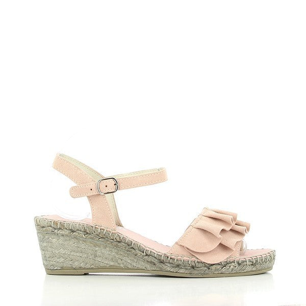 A pair of Calzanor 743 Pink Slingback Wedge Espadrilles elegantly displayed on a neutral surface. The espadrilles feature a soft pink leather upper, complemented by a sleek round toe and a comfortable slingback strap. The 5.5 cm wedge heel showcases a natural jute sole, emphasizing the eco-friendly craftsmanship. The overall design exudes a blend of modern style and classic espadrille charm, making them a versatile choice for both casual and dressy occasions. 