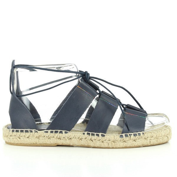 The photo features the Calzanor 93003PO Navy Lace-Up Espadrilles, beautifully displayed from multiple perspectives to showcase their stylish design. The side view highlights the rich navy leather upper, contrasting elegantly with the natural jute sole, creating a sophisticated and versatile look. The lace-up detail is prominently featured, emphasizing both the adjustable fit and the modern aesthetic of the espadrilles.